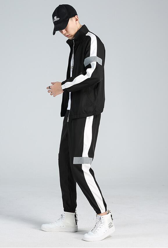 Casual wear trendy handsome guard clothes on male model featuring sporty black jacket and pants.
